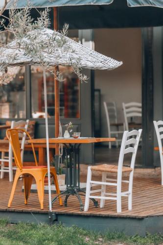 a table and chairs and an umbrella on a deck at Attalos Suites Hotel in Bergama