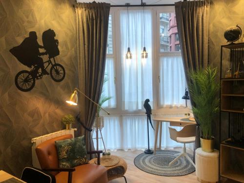 a living room with a bike on the wall at Pensión Boutique Caravan Cinema in Bilbao