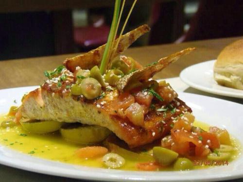 a white plate with a piece of food on a table at Awa Resort Hotel in Encarnación