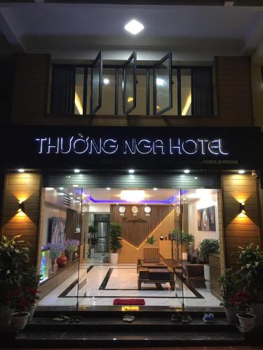 a building with a sign for a hotel at night at Nhà nghỉ Thường Nga in Cat Ba