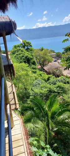 a view of the ocean from a balcony of a house at Villa Girassol in Ilhabela