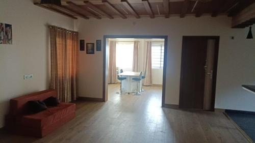 a living room with a couch and a table at Salora Kodai in Kodaikānāl