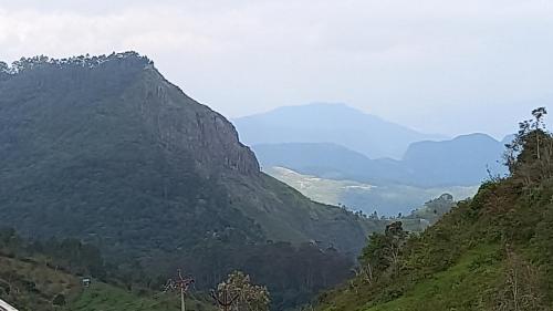 a view of a valley with mountains in the background at Salora Kodai in Kodaikānāl