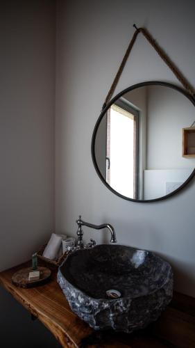 a bathroom with a stone sink and a mirror at Ca di Timo B&B in Salionze