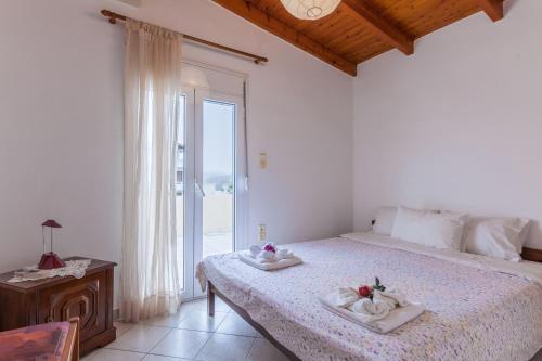 a bedroom with a bed with towels on it at Ioannis Appartment in Heraklio Town