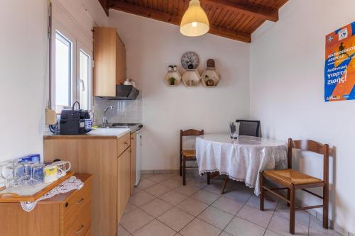 a kitchen with a table and a kitchen with a table and chairs at Ioannis Appartment in Heraklio Town