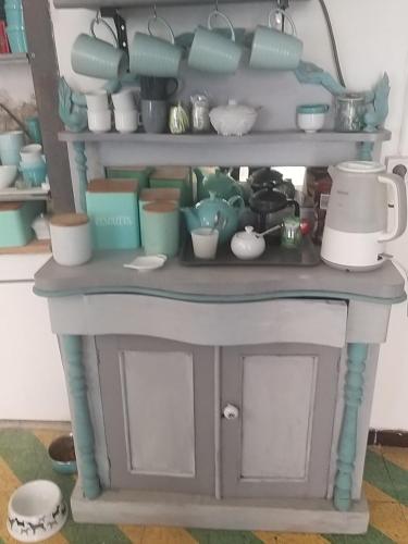 a shelf full of dishes and pots and pans at La Vannière in Le Poujol-sur-Orb