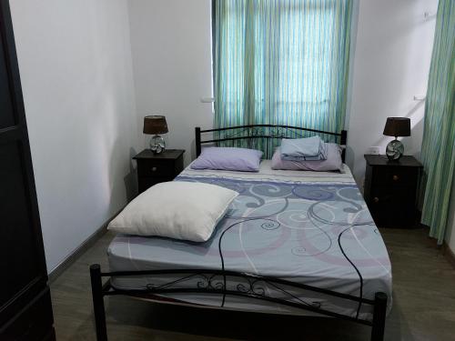 a bedroom with a bed with two pillows on it at Villa Eglantine in Grand Gaube