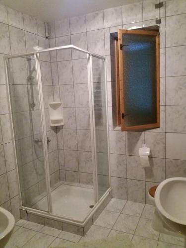 a shower with a glass door in a bathroom at Guest House - Wai derhim in Sibiu