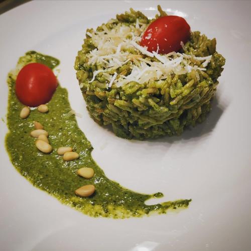 a plate of food with a green dessert with tomatoes at Lions' Luxury Eco Resort & Spa in Malindi
