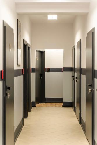 a corridor of doors in an office building at Gems Hostel in Głogów