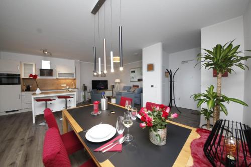 a living room and kitchen with a dining room and a table at Ferienwohnung Kerst in Schweigen-Rechtenbach