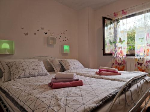 a bed with two pillows on it in a bedroom at Apartman Sandro in Motovun