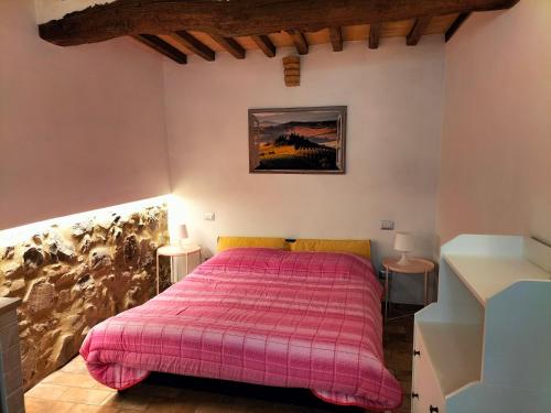 Giường trong phòng chung tại Casetta di Ghino