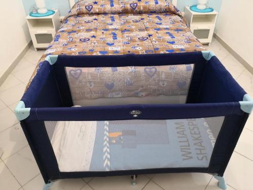 a bed with a blue frame in a room at Short Lets Vacanze "Massimo" in Trappeto