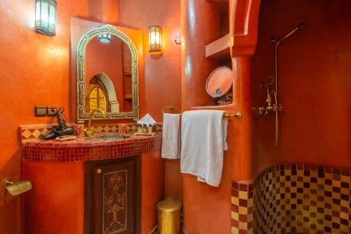 a bathroom with a sink and a mirror at Riad AZARO in Marrakesh
