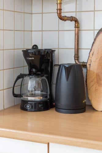 a coffee maker sitting on a counter next to a toaster at Apartma Valsar Rogla in Zreče