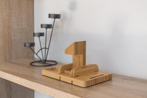 a wooden object sitting on top of a wooden shelf at Apartma Valsar Rogla in Zreče