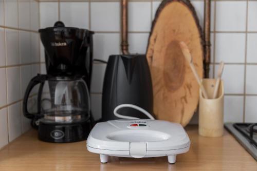 a white toaster sitting on top of a kitchen counter at Apartma Valsar Rogla in Zreče