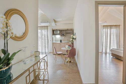 a kitchen and living room with a table and chairs at Socrates Apartments in Skala Kefalonias