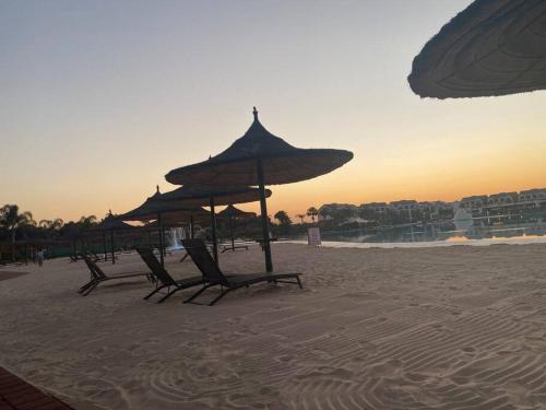 a group of chairs and umbrellas on a beach at TK’s Penthouse - The Blyde in Pretoria