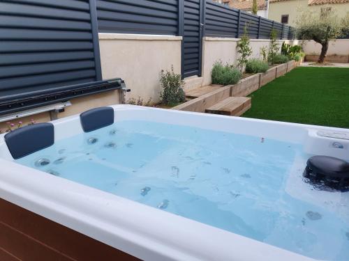 a hot tub in the backyard of a house at Escape to a spacious retreat with garden in Avinyonet de Puigventós