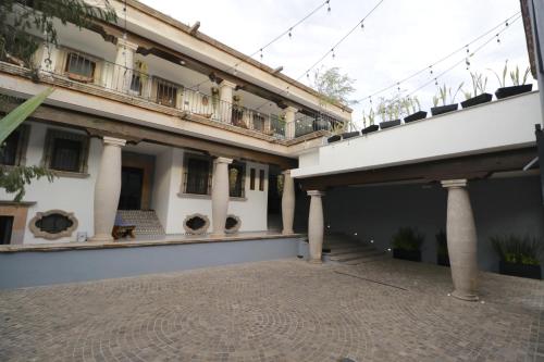an external view of a building with a courtyard at Hotel Boutique Casa Loreta in Querétaro