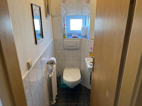 a small bathroom with a toilet and a window at FeWo HoLiDay HouSE Allgäu in Ottobeuren