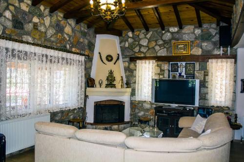 a living room with two couches and a fireplace at VILLA GEM in Skiathos Town