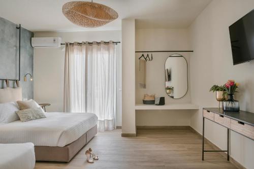 a bedroom with a large bed and a mirror at Socrates Apartments in Skala Kefalonias