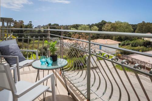 a balcony with a table and chairs and a view at Socrates Apartments in Skala Kefalonias