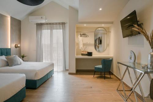 a hotel room with a bed and a desk at Socrates Apartments in Skala Kefalonias