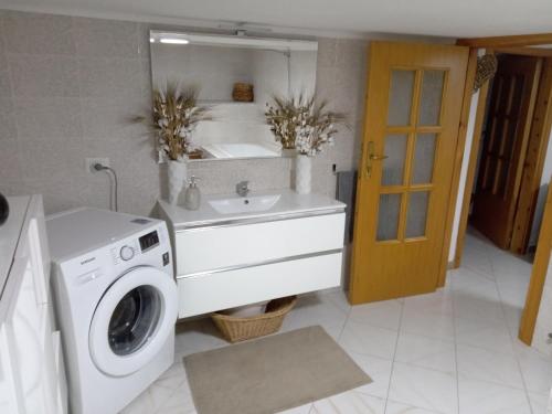a bathroom with a washing machine and a sink at Casa Maria in Scauri