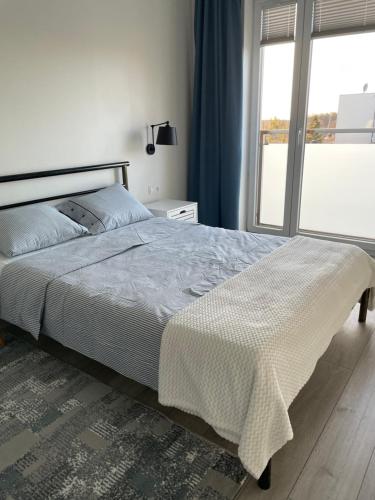 Posteľ alebo postele v izbe v ubytovaní Apartament Dziewiątka