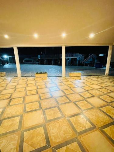 an empty room with a tiled floor in a building at Panorama Luxury House in Nathia Gali