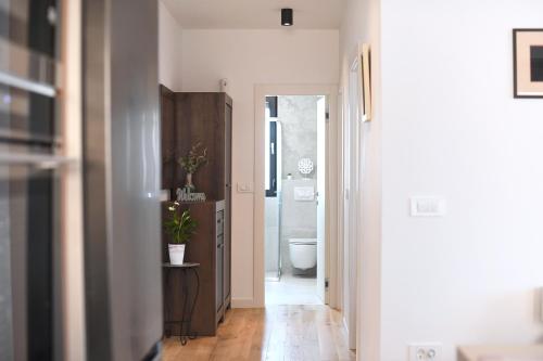 a hallway with a bathroom with a sink and a toilet at Apartment Maritimo in Zadar