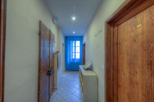 a hallway with a wooden door and a table in a room at Sogni D'Oro Guest House in Florence