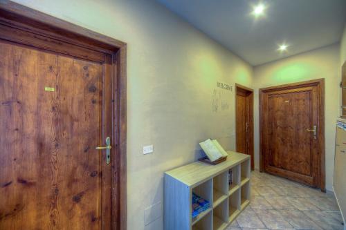 a room with a door and a shelf with a sign at Sogni D'Oro Guest House in Florence