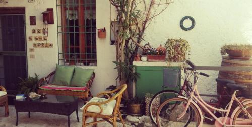 a bike parked next to a building with a chair and a table at La Casa di Marla in Sirmione