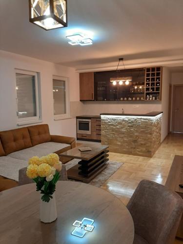 a living room with a couch and a table at Apartman Dionis in Užice