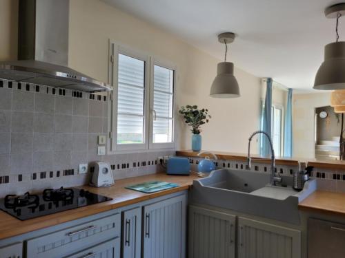 a kitchen with a sink and a counter top at La Prée in Angé