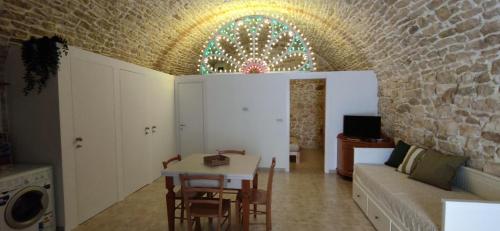 a living room with a couch and a table at PIETRAVIVA Housing in Molfetta