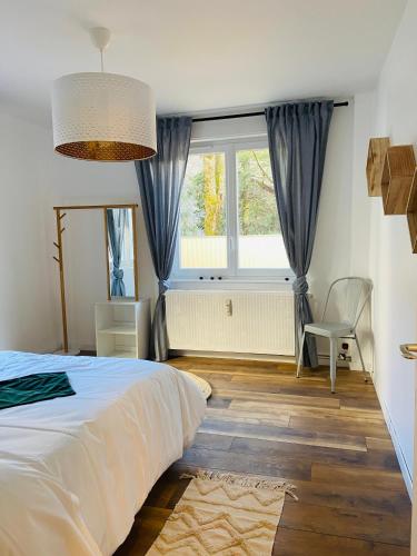 Ένα ή περισσότερα κρεβάτια σε δωμάτιο στο Appartement 2 chambres avec terrasse vue sur jardin arboré