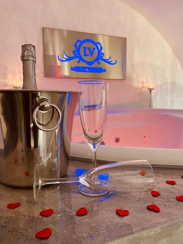 a wine glass sitting on a counter next to a bath tub at Casa vacanza salento luxury virginia in Racale