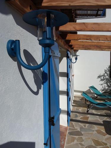 a blue light under a porch with a wooden ceiling at Luciana in La Croix-Valmer