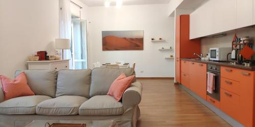 a living room with a couch and a kitchen at Terrazza di San Paolo in Rome