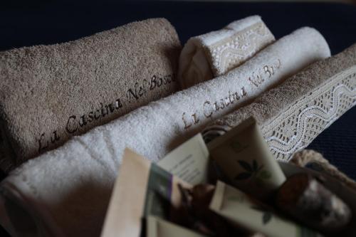 a pile of towels with writing on them at La Cascina Nel Bosco in Faicchio