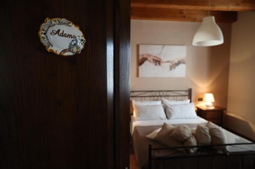 a bedroom with a bed and a clock on the wall at La Cascina Nel Bosco in Faicchio