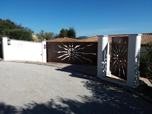 a fence with a gate with a painting on it at Luciana in La Croix-Valmer