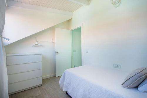 a white bedroom with a bed and a closet at FABULOUS BUNGALOW , WIFI, SWIMMING POOL AND BEACH in Pasito Blanco